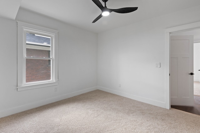 unfurnished room featuring carpet, ceiling fan, and baseboards