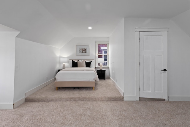 bedroom featuring lofted ceiling, carpet floors, and baseboards