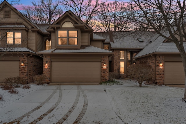 view of front facade featuring a garage and brick siding