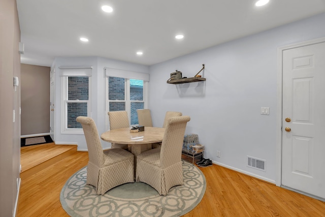 dining space with baseboards, light wood-style flooring, visible vents, and recessed lighting