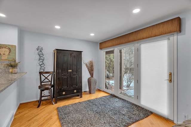 entryway featuring light wood finished floors, baseboards, and recessed lighting