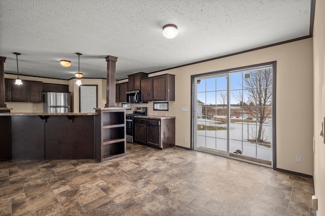 kitchen with dark brown cabinets, appliances with stainless steel finishes, a breakfast bar area, and baseboards