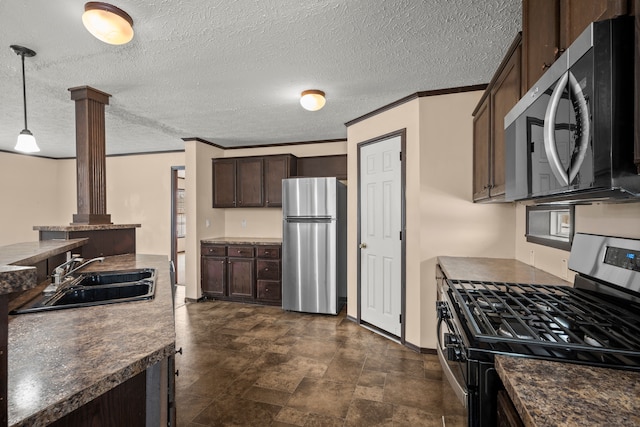 kitchen featuring crown molding, dark countertops, appliances with stainless steel finishes, a sink, and dark brown cabinets