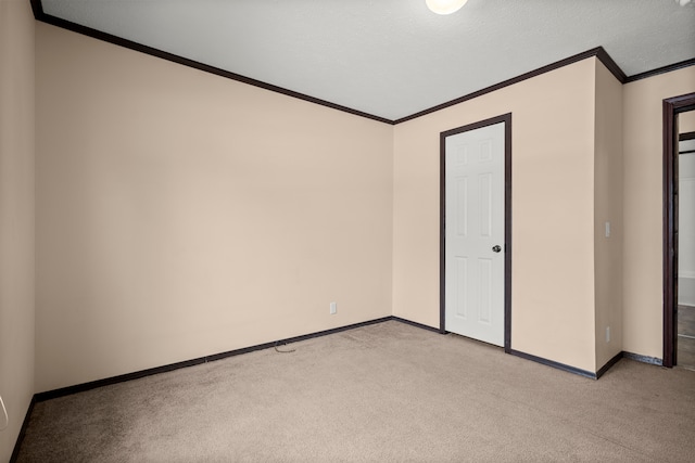 unfurnished bedroom with baseboards, ornamental molding, and light colored carpet