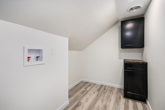 bonus room with light wood finished floors, visible vents, baseboards, and vaulted ceiling