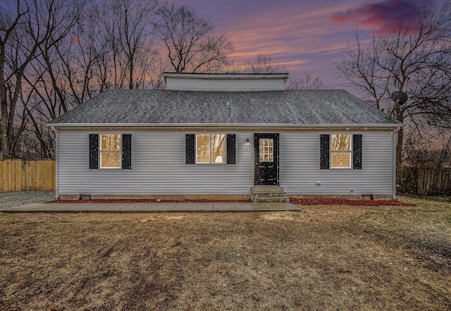 view of front of home featuring crawl space, a shingled roof, a yard, and fence