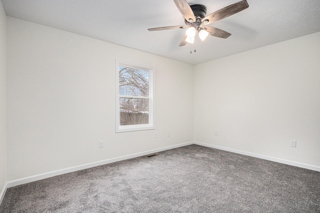 carpeted empty room featuring visible vents, a textured ceiling, a ceiling fan, and baseboards