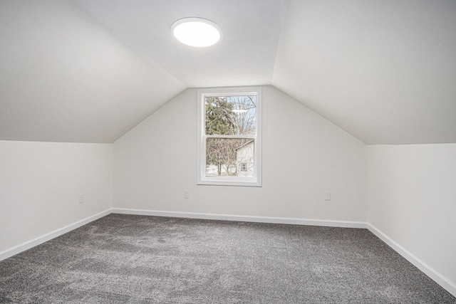 bonus room with lofted ceiling, carpet flooring, and baseboards