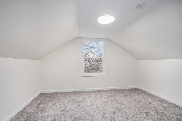 bonus room with lofted ceiling, carpet, and baseboards