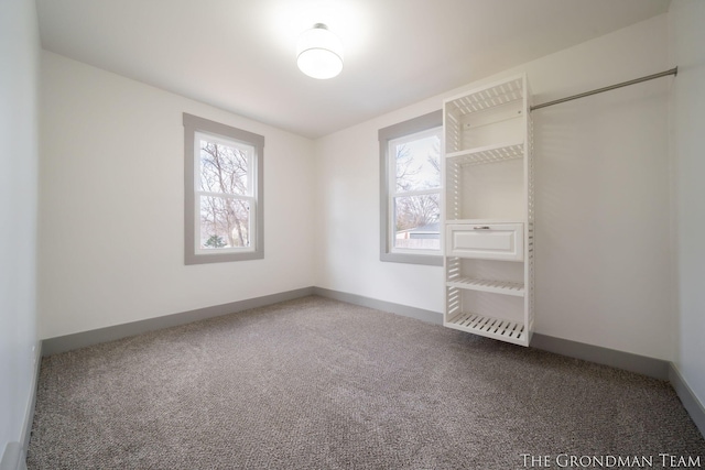 interior space featuring carpet and baseboards