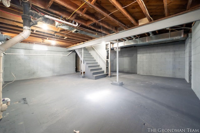 unfinished basement featuring stairway