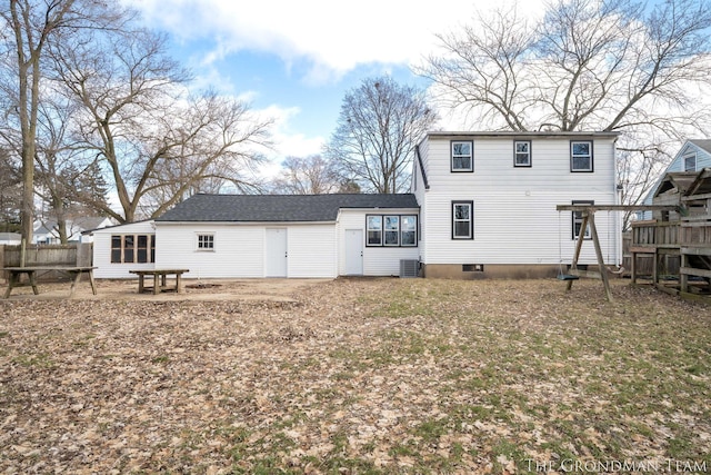 rear view of property featuring central AC and fence