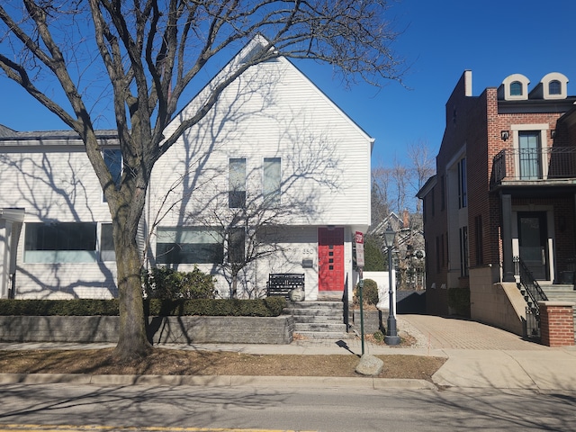 multi unit property with decorative driveway and a balcony