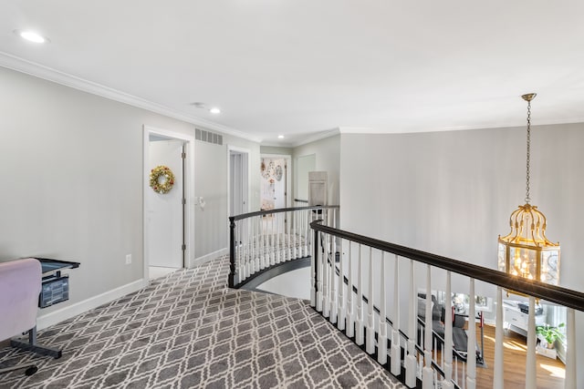 corridor with visible vents, an upstairs landing, ornamental molding, recessed lighting, and baseboards