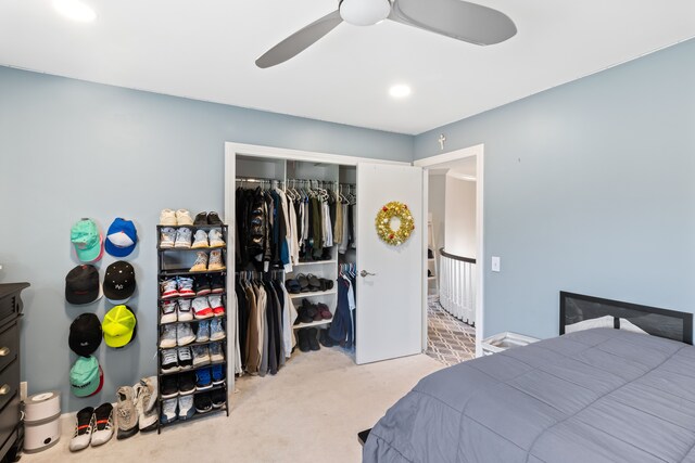 carpeted bedroom featuring a closet and ceiling fan