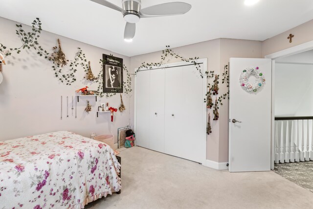 bedroom featuring a ceiling fan, light colored carpet, and a closet