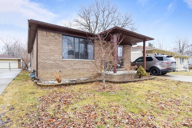 view of front facade with a front lawn and brick siding