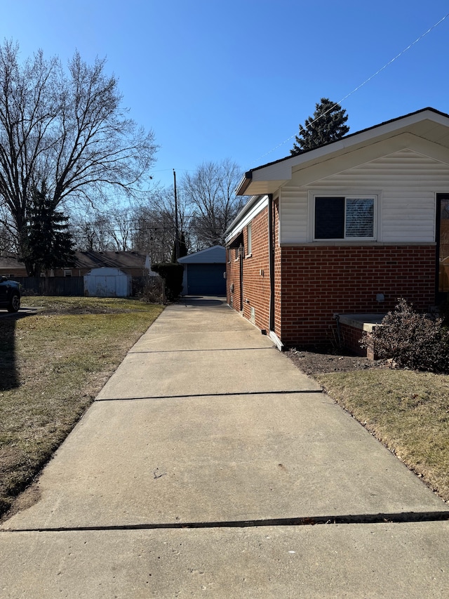 view of property exterior featuring an outbuilding and brick siding