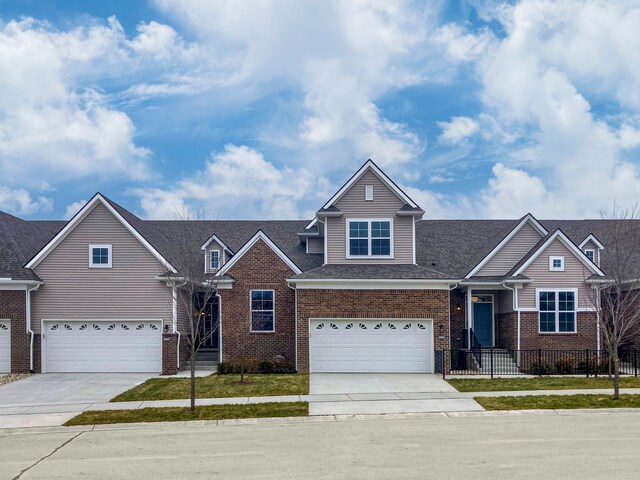 view of front of house with an attached garage, brick siding, and concrete driveway