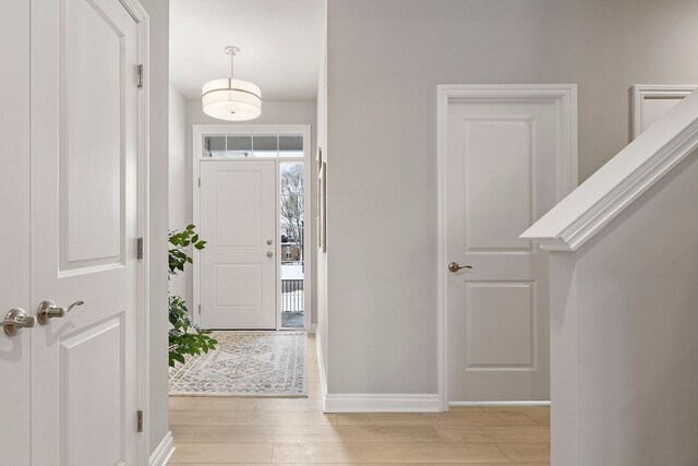 entryway with baseboards and light wood-style floors
