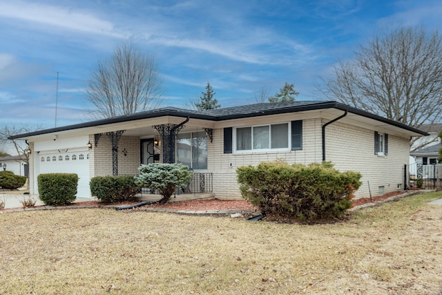 ranch-style home featuring an attached garage, crawl space, a front lawn, and brick siding