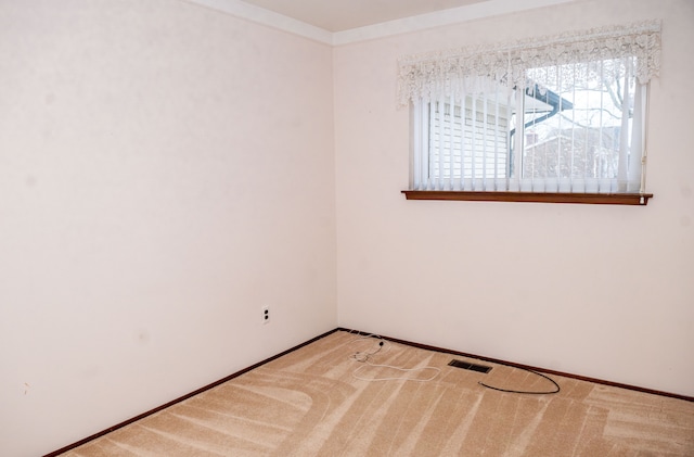 unfurnished room featuring baseboards, visible vents, and carpet flooring