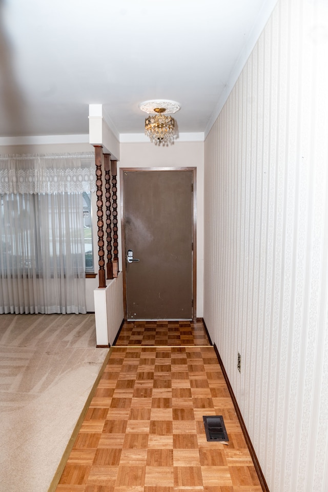 interior space with visible vents, a chandelier, and crown molding