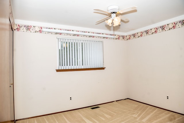 unfurnished room featuring carpet, visible vents, ceiling fan, and baseboards