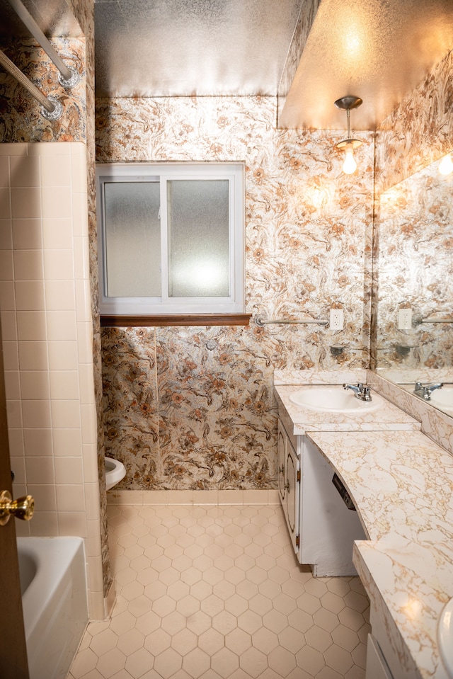 bathroom with wallpapered walls, tile patterned flooring, and vanity