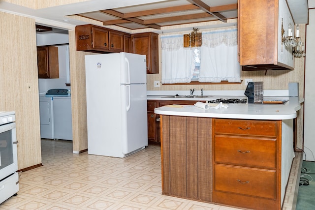 kitchen with coffered ceiling, white appliances, light countertops, and a sink