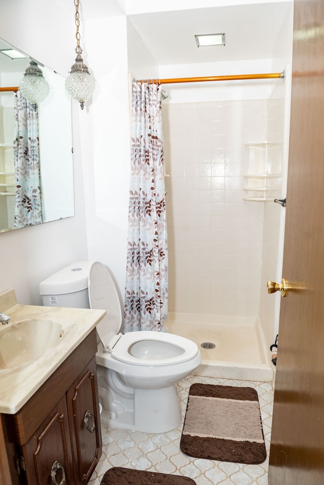 full bathroom with vanity, a shower stall, and toilet