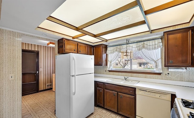 kitchen featuring white appliances, light countertops, a sink, and light floors