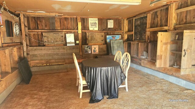 dining room with wooden walls