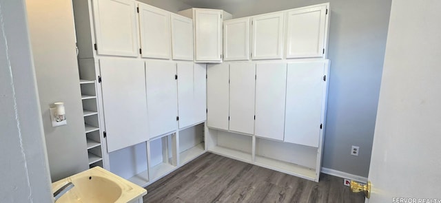 mudroom featuring baseboards and wood finished floors