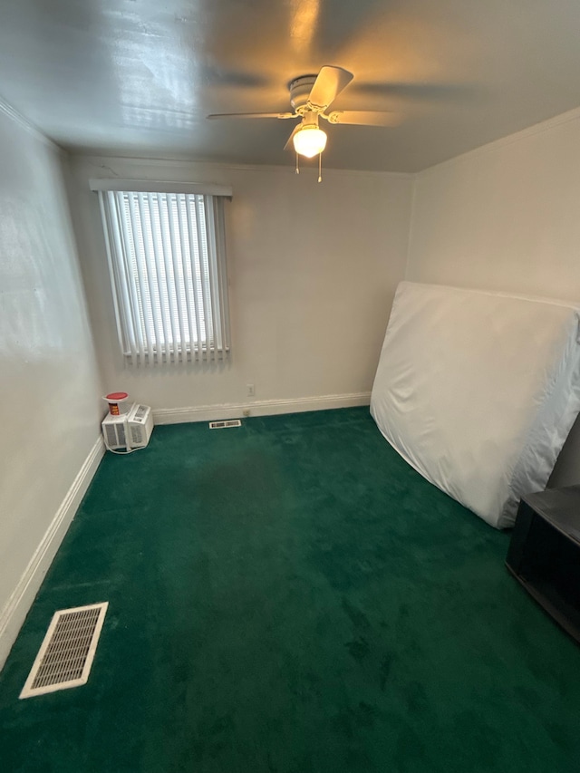 unfurnished bedroom with visible vents, baseboards, carpet, and a ceiling fan