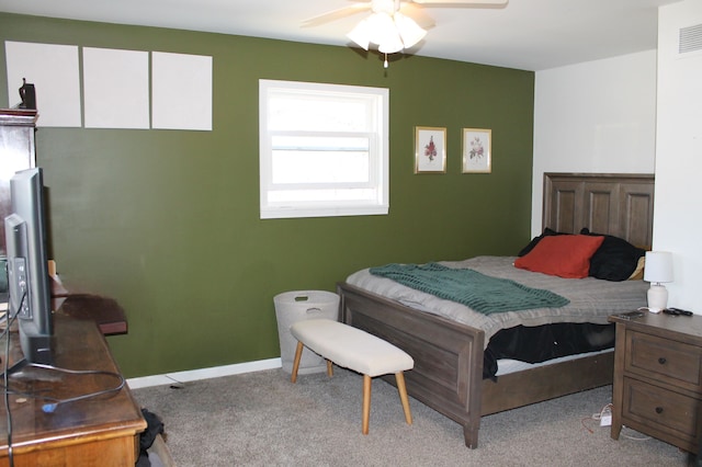 carpeted bedroom with visible vents, a ceiling fan, and baseboards