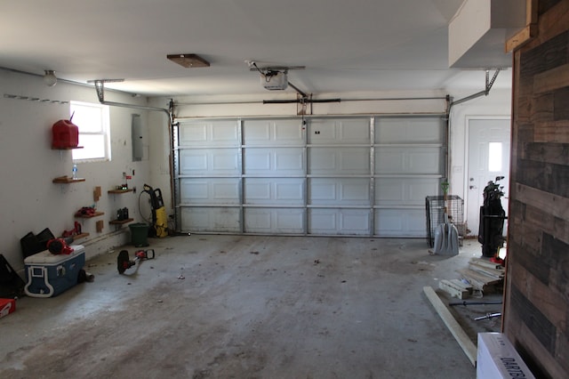 garage featuring electric panel and a garage door opener