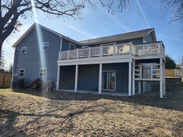 rear view of property featuring a patio, a wooden deck, central AC, and fence