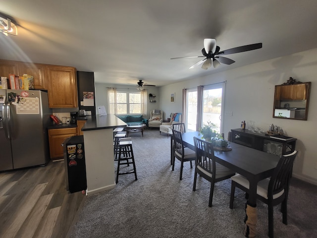 dining space featuring baseboards and ceiling fan