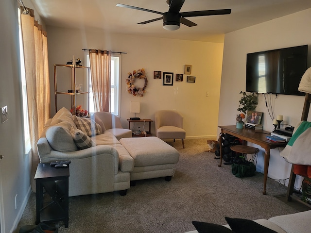 living room featuring carpet flooring, a ceiling fan, and baseboards