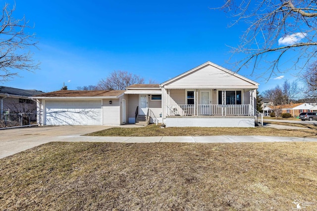 view of front of home featuring a porch, an attached garage, a front yard, and driveway