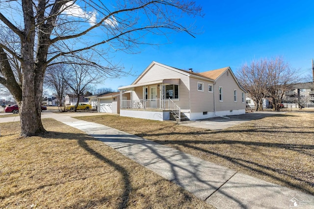 view of property exterior featuring a lawn, driveway, a porch, a garage, and a chimney