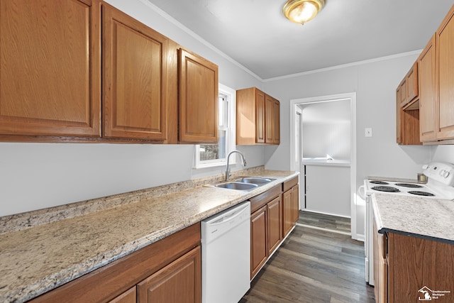 kitchen with white appliances, brown cabinetry, dark wood finished floors, ornamental molding, and a sink