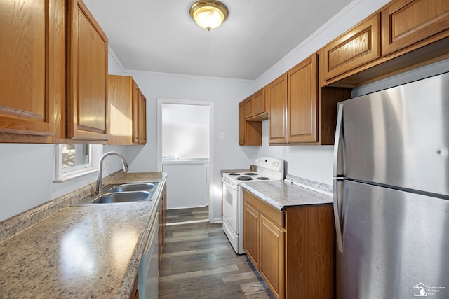 kitchen featuring white appliances, dark wood finished floors, a sink, crown molding, and brown cabinets