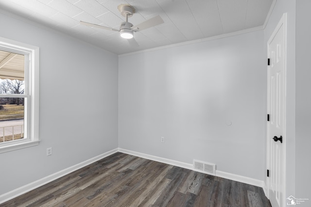 unfurnished room featuring visible vents, baseboards, dark wood-type flooring, and a ceiling fan