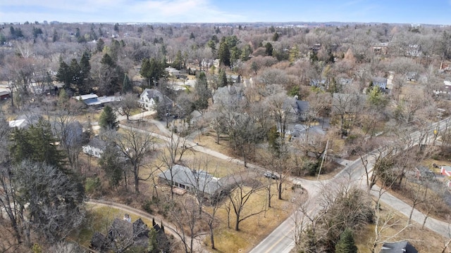 drone / aerial view with a wooded view