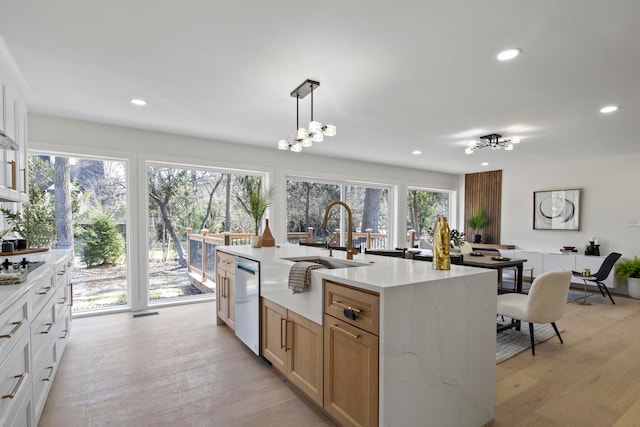 kitchen featuring stainless steel dishwasher, recessed lighting, light wood-type flooring, and a sink