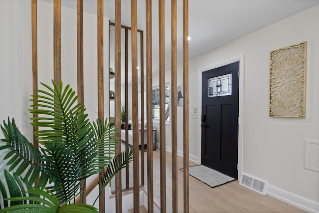 entryway with visible vents, baseboards, and light wood-style flooring