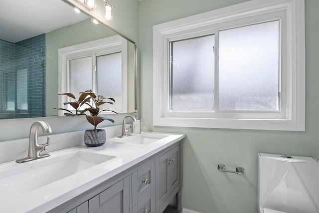 full bath with double vanity and a sink