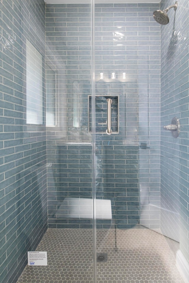 full bath featuring a shower stall